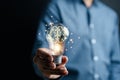 Hand man holding illuminated lightbulb, idea, innovation and inspiration with glowing virtual brain, smart intelligent creativity Royalty Free Stock Photo