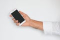 Hand of a man holding mobile smart phone with black display isolated on light gray background.