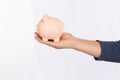 Hand of man holding a pink piggy bank isolated on white background, saving concept Royalty Free Stock Photo