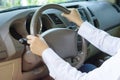 Hand of the man holding on the steering wheel while driving a car Royalty Free Stock Photo