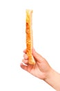 Hand man holding stick puff pastry with sesame seeds. Isolated on a white background Royalty Free Stock Photo