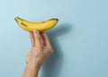Hand a man holds banana with a copy space