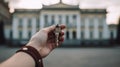 the hand of a man holds a key against the backdrop of the White House Royalty Free Stock Photo