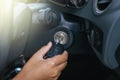 Hand of man inserting key to start car system,Button on dashboard in car Royalty Free Stock Photo