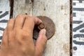 Hand man install rusty nut and bolt on wood Royalty Free Stock Photo