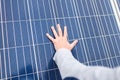 The hand of man lies on the panel of a solar battery. Royalty Free Stock Photo