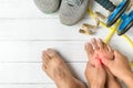 Hand man massaging his painful foot, red hi-lighted on pain area Royalty Free Stock Photo