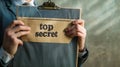 Hand of a man opening an folder with word top secret Royalty Free Stock Photo