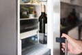 Hand of a man opening refrigerator door in domestic kitchen Royalty Free Stock Photo