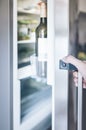 Hand opening refrigerator door in kitchen Royalty Free Stock Photo