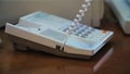 A hand of a man picking up the receiver of a vintage retro telephone and answering the call. Media. Close up of using Royalty Free Stock Photo