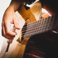 Hand of a man playing an wooden acoustic guitar on a white background Royalty Free Stock Photo