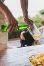 Hand of a man pouring beer from a bottle in a glass. Royalty Free Stock Photo