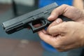 A hand of man practicing firing using a Glock gun model at the shooting range. Fire glock hand gun