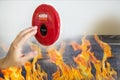 Hand of man pulling fire alarm switch on the white wall as background for emergency case at the new factory building. Royalty Free Stock Photo