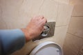 Hand of man push toilet flush press with two separate buttons Royalty Free Stock Photo