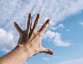 Hand of a man reaching to towards sky. Royalty Free Stock Photo