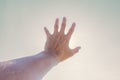 Hand of man reaching to towards sky. Hand make symbol Royalty Free Stock Photo