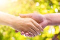 Hand man Shake hands on green bokeh background Royalty Free Stock Photo