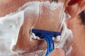 Hand man shaves his face closeup Royalty Free Stock Photo