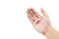 A hand of a man with some capsule pills on white background. Royalty Free Stock Photo