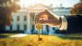 the hand of a man in a suit holds a key against the backdrop of the White House Royalty Free Stock Photo