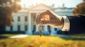 the hand of a man in a suit holds a key against the backdrop of the White House Royalty Free Stock Photo