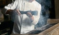 Chef cooking beef steak on bbq in restaurant kitchen Royalty Free Stock Photo