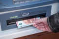 Hand of man taking money at the automated machine of Royalty Free Stock Photo