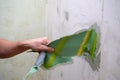 Hand of a man to tear the old bright wallpaper from the wall. Preparing for home renovation work Royalty Free Stock Photo