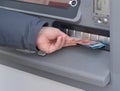 Hand of man to withdraw money from an ATM