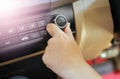 Hand of man turning on car air conditioning system,Button on dashboard in car Royalty Free Stock Photo