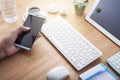 Hand man use tablet smartphone with Office desk wood table of Bu Royalty Free Stock Photo