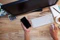 Hand man use tablet smartphone with Office desk wood table of Bu Royalty Free Stock Photo