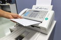 Hand man are using a fax machine in the office