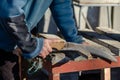 hand of a man using a saw, sawing a piece of wood Royalty Free Stock Photo