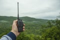 In the hand of a man walkie talkie for outdoor.