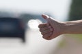 Hand of a man who honks to passing cars, hitchhiking trip Royalty Free Stock Photo
