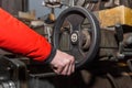 The hand of a man worker holds a special, steering wheel by the handle and controls the work of the milling machine in an Royalty Free Stock Photo