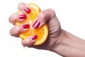 Hand with manicured nails touch an orange on white Royalty Free Stock Photo