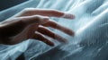 A hand manipulates a translucent composite material sheet, symbolizing innovation in composite manufacturing Royalty Free Stock Photo