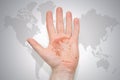 Hand with map of greece on the gray world map background Royalty Free Stock Photo