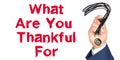 Hand with marker writing: What Are You Thankful For