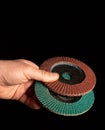 Hand of the master hold two Flap Discs close up on black background Royalty Free Stock Photo