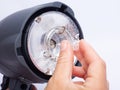 Hand master replaced the burnt out bulb in a pulse photo flash Royalty Free Stock Photo