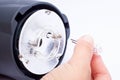 Hand master replaced the burnt out bulb in a pulse photo flash .changing flashlight bulbs Royalty Free Stock Photo