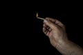 Hand and match on black background Royalty Free Stock Photo