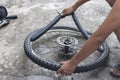 Hand of a mechanic is changing the tires of the bicycle.