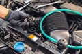 Hand of Mechanic check water in car radiator and add water antIfreeze coolant fluid to car radiator at garage , service and