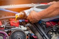 Hand mechanic repairing car,Change the Oil or Pouring fresh oil to car engine